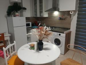 a white table with a vase on it in a kitchen at Apartamentos de la mansión in Carmona +11 photos