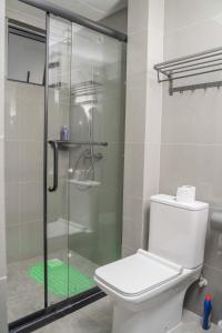 a bathroom with a toilet and a glass shower at Iconic 1Br in Riverside with views and gym in Nairobi