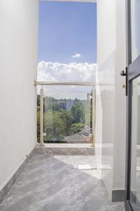 a room with a large window with a view at Iconic 1Br in Riverside with views and gym in Nairobi