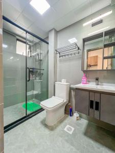 a bathroom with a shower and a toilet and a sink at Iconic 1Br in Riverside with views and gym in Nairobi