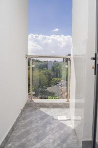 a room with a large window with a view at Iconic 1Br in Riverside with views and gym in Nairobi
