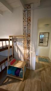 a bunk bed in the corner of a room at Suíte 1 - Zeh Guest house in Imbituba