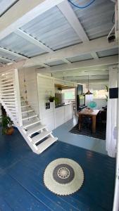 a living room with a staircase in a house at Suíte 1 - Zeh Guest house in Imbituba +10 photos