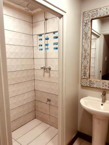 a bathroom with a shower and a sink at Villa Rose in Paramaribo
