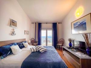 a bedroom with a bed and a desk with a television at Apartments Panorama in Senj +41 photos
