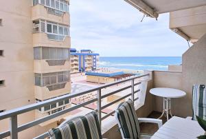 a balcony with chairs and a view of the ocean at Las Nuevas Sirenas en La Manga in La Manga del Mar Menor