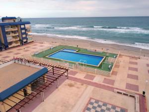 an overhead view of a swimming pool next to a beach at Las Nuevas Sirenas en La Manga in La Manga del Mar Menor