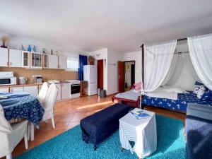 a living room with two beds and a kitchen at Apartments Panorama in Senj