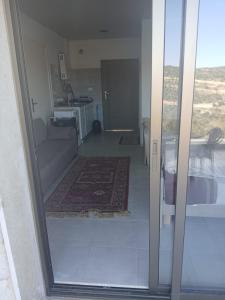 an open door to a room with a living room at La MAISON DU VAL in Jbeil