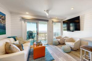 a living room with a couch and chairs and a television at Sea Cabin 339-C in Isle of Palms