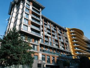 a tall building with a tree in front of it at MELVİN HOMe in Istanbul