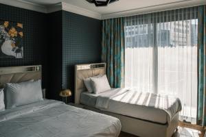 a bedroom with two beds and a window at MELVİN HOMe in Istanbul +53 photos