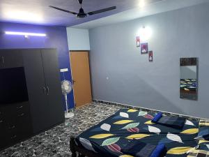 a bedroom with a bed and a ceiling fan at Private Room in Independent Villa in Azossim