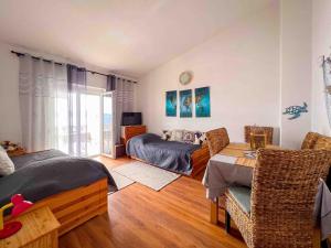 a bedroom with a bed and a table with chairs at Apartments Panorama in Senj