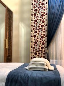 a hotel room with a bed with a towel on it at Daro Boutique in Bukhara