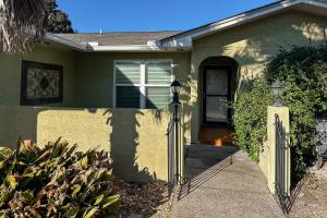 a house with a gate in front of it at The MOasis in Panama City Beach