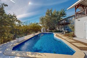 a swimming pool in the backyard of a house at Hill Country Getaway in Spicewood