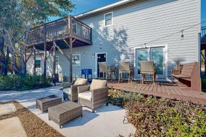 a patio with chairs and a deck on a house at Hill Country Getaway in Spicewood