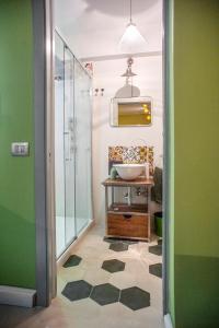 a bathroom with a sink and a glass shower at Terrazza Munira Trastevere in Rome