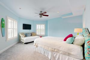 a bedroom with blue walls and a bed and a couch at The Chancellery --- 6 Hall Ave in Dewey Beach
