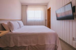 Postel nebo postele na pokoji v ubytování Novíssimo com Varanda Gourmet 10 min a pé da praia