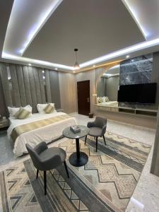 a hotel room with a bed and a flat screen tv at سماء البوادي للشقق المفروشة in Jeddah +31 photos