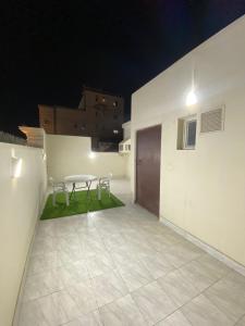 a patio with a table and two chairs on it at سماء البوادي للشقق المفروشة in Jeddah