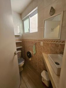 a bathroom with a sink and a toilet and a mirror at Habitación privada Depa B in Jardines de la Hacienda +31 photos