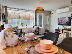 a living room with a table with dishes on it at The Old Post Office - MaisonPro in Stroud