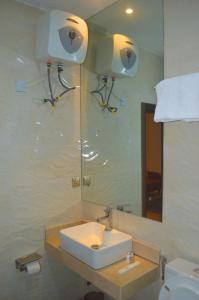 a bathroom with a sink and a mirror at Caritas Inn Lekki in Lagos