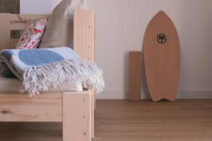 a bedroom with a wooden surfboard next to a bed at Casa Ondas - Ocean-Inspired Stay in Fão