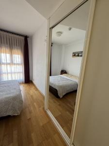 a large mirror in a bedroom with a bed and a bed sqor at Casa con piscina in Madrid +20 photos