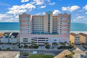 an apartment building with the ocean in the background at LAG902 Laguna Keys Oceanfront 4BR/3B Condo in Cherry Grove in Myrtle Beach