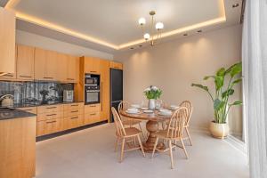 a kitchen with a table and chairs in a room at Vadis Luxury Villa Rhodes in Koskinou