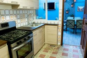 a kitchen with a stove and a sink at Casa 080 in Guatemala +20 photos