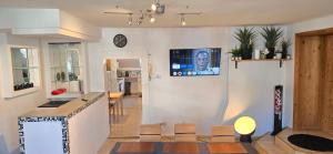 a kitchen and living room with a tv on the wall at Bright & Spacious Stay in Graz in Graz