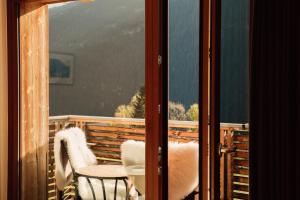 a view of a balcony with a table and chairs at Tanafreida Berg-Refugium in Sankt Gallenkirch