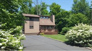 a house with a driveway in front of it at The CubHouse Poconos getaway in Tobyhanna