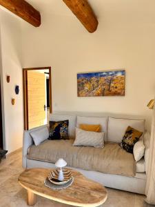a living room with a couch and a table at Mazet LEAJO 2 in Eygalières