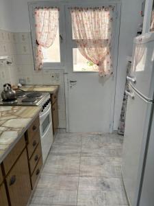 a kitchen with a stove and a white refrigerator at Monoambiente frente al mar in Monte Hermoso