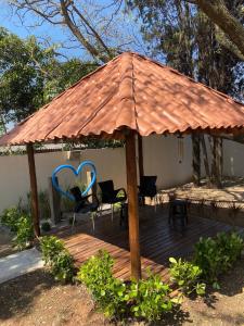 a wooden deck with a gazebo with a roof at pousada ranchinho sorocaba in Sorocaba