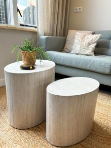 a living room with two tables and a couch at Casa Bon Bini in Egmond aan Zee