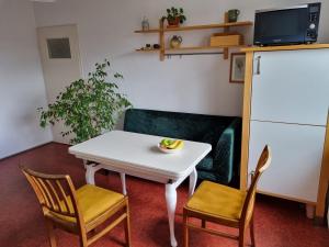 a living room with a white table and two chairs at Tischfussball Quartier Köln-Niehl in Cologne +13 photos