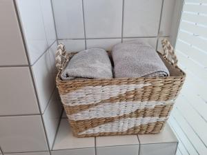 a basket of towels sitting on a shelf in a bathroom at Tischfussball Quartier Köln-Niehl in Cologne
