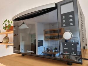 a room with a window with a kitchen in it at Tischfussball Quartier Köln-Niehl in Cologne