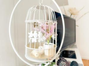 a bird cage with figurines in it on a desk at - Le COSY GARDEN - Proche RER A et E - Paris Disney - Parking et WIFI Gratuit ! Family SPECIAL OFFER in Champigny-sur-Marne