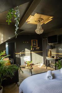 a bedroom with a bed and a desk in a room at Le Glam Divin in Nantes