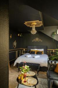 a bedroom with a bed and a table with plates on it at Le Glam Divin in Nantes