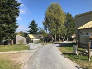 a road in a village with a building and trees at Gîte cocon Vassivière Aux abords du lac in Lac de Vassivière +12 photos