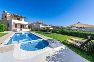 a swimming pool in the backyard of a house at Armonia Villa with Sea View in Plakias